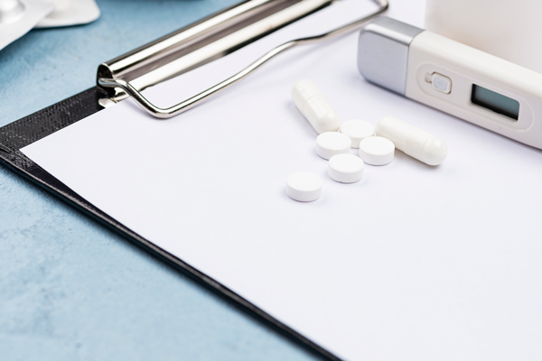 scattered pills on clipboard